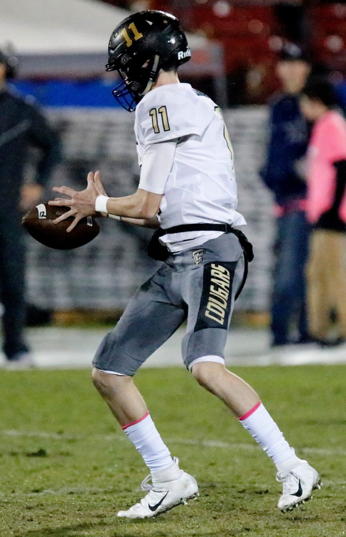 The Colony High School quarterback Kenneth Harrington (11) looses the handle on a wet...