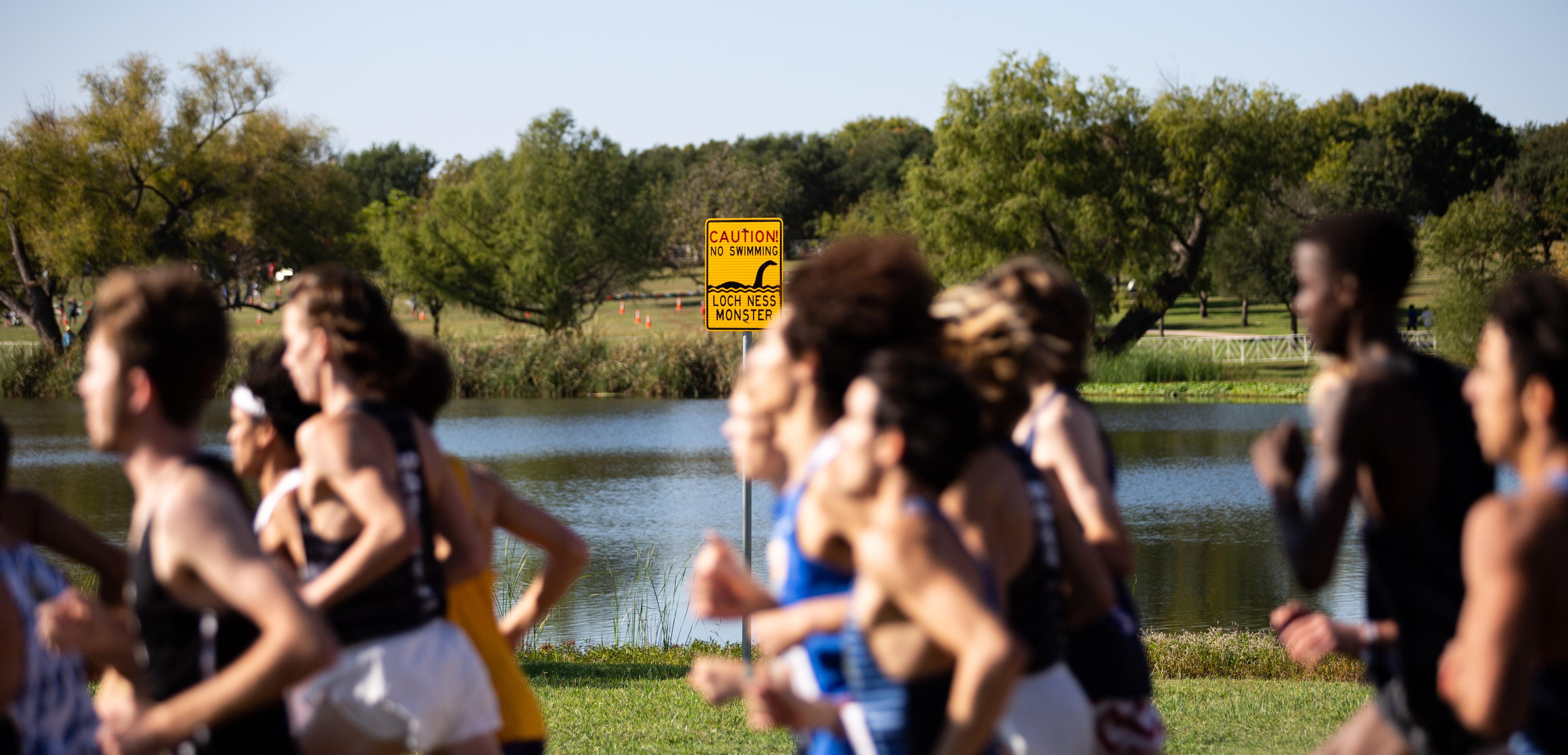 Competitors in the 5A boys’ 5k race run through Old Settlers Park during the UIL Cross...