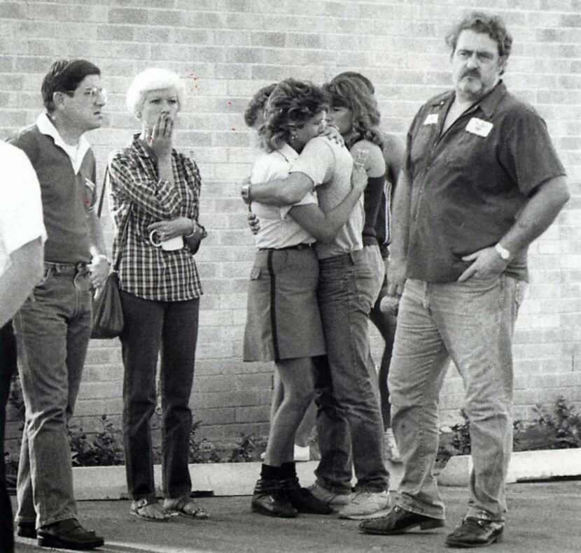 Friends and relatives mourn outside the Edmond, Okla., post office on Aug. 20, 1986. Pat...