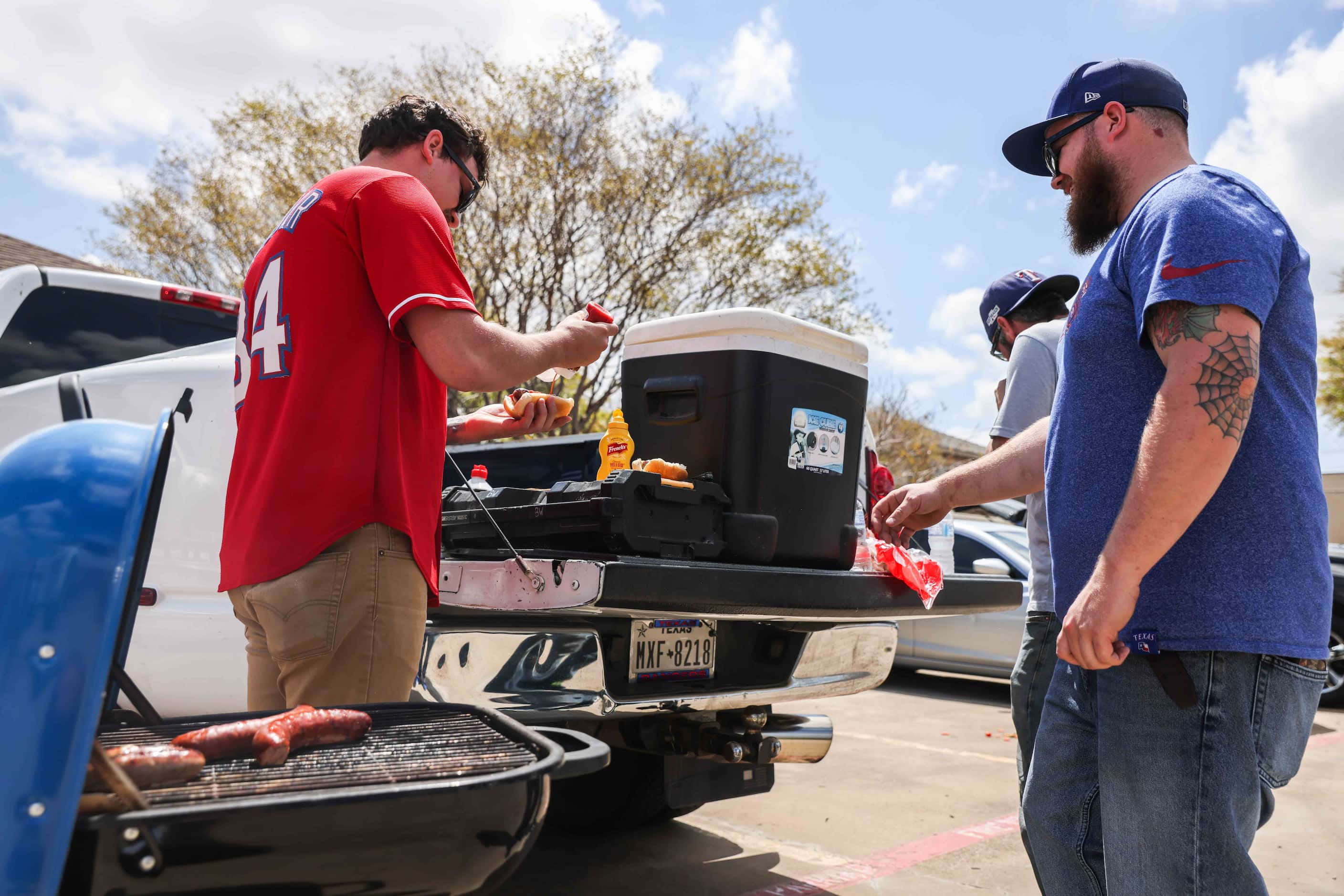 From left Dylan Huerta, Beau Wyse and Kary Krafve get a meal outside the Globe Life Field...