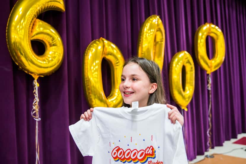 Sixth-grader Alanna Mazeffa, 11, is celebrated as the 60,000th student to be enrolled in...