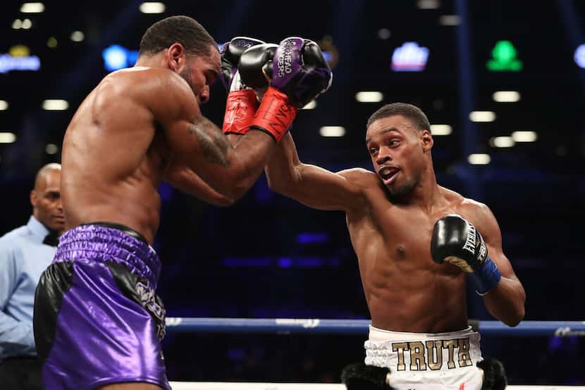 NEW YORK, NY - JANUARY 20:  Errol Spence punches Lamont Peterson during their IBF...