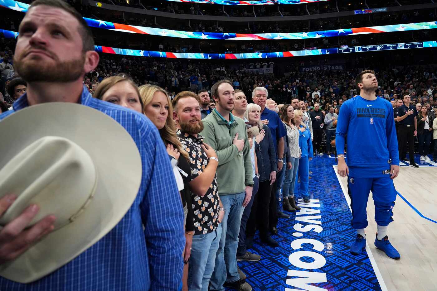 Dallas Mavericks guard Luka Doncic stands for the national anthem before an NBA basketball...