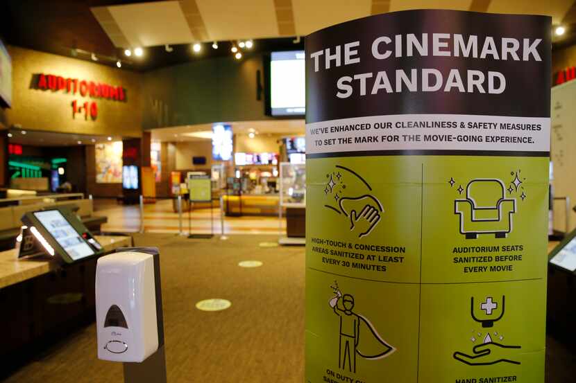 Signage noting new cleanliness and safety measures at Cinemark West in Plano, one of the...