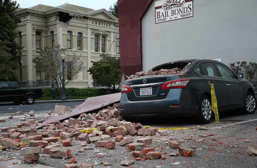 NAPA, CA - AUGUST 24:  Bricks from a damaged building sit on a car following a reported 6.0...
