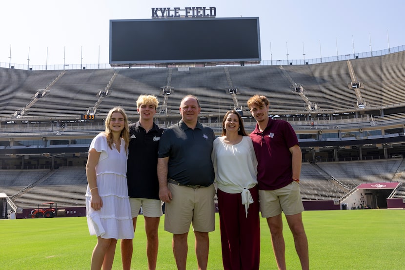 Texas A&M head coach Mike Elko poses for a family photo with his wife, Michelle, and their...