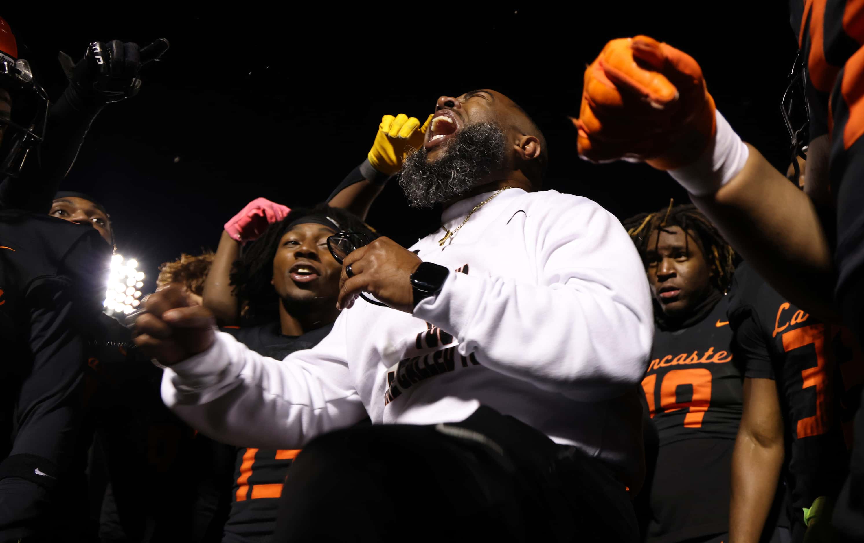 Lancaster head coach Leon Paul, center, lets out a victory yell as he celebrates with his...