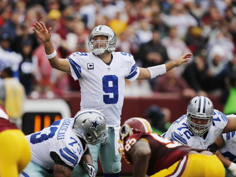 Dallas Cowboys quarterback Tony Romo directs the offense against the Washington Redskins,...