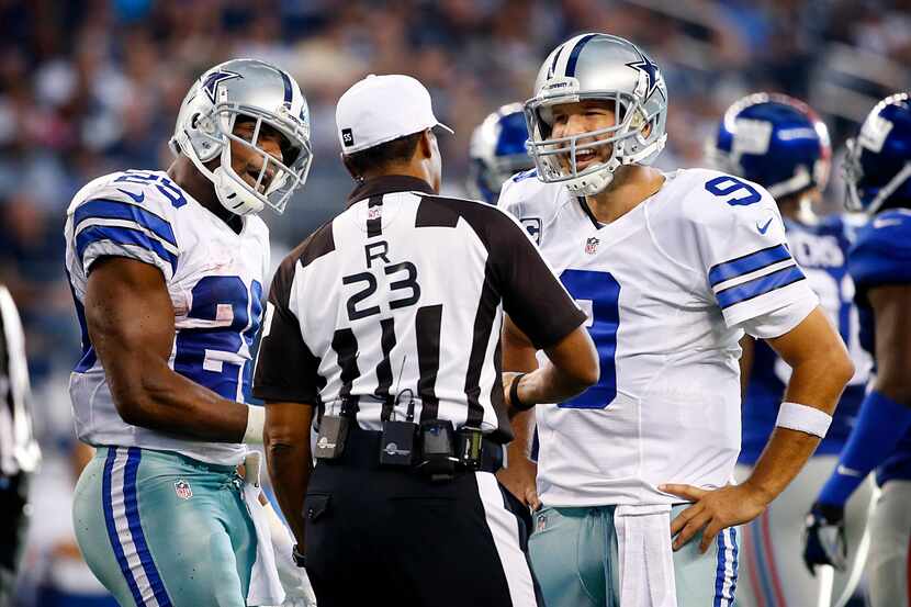 Dallas Cowboys quarterback Tony Romo (9) and running back DeMarco Murray (29) contest a call...