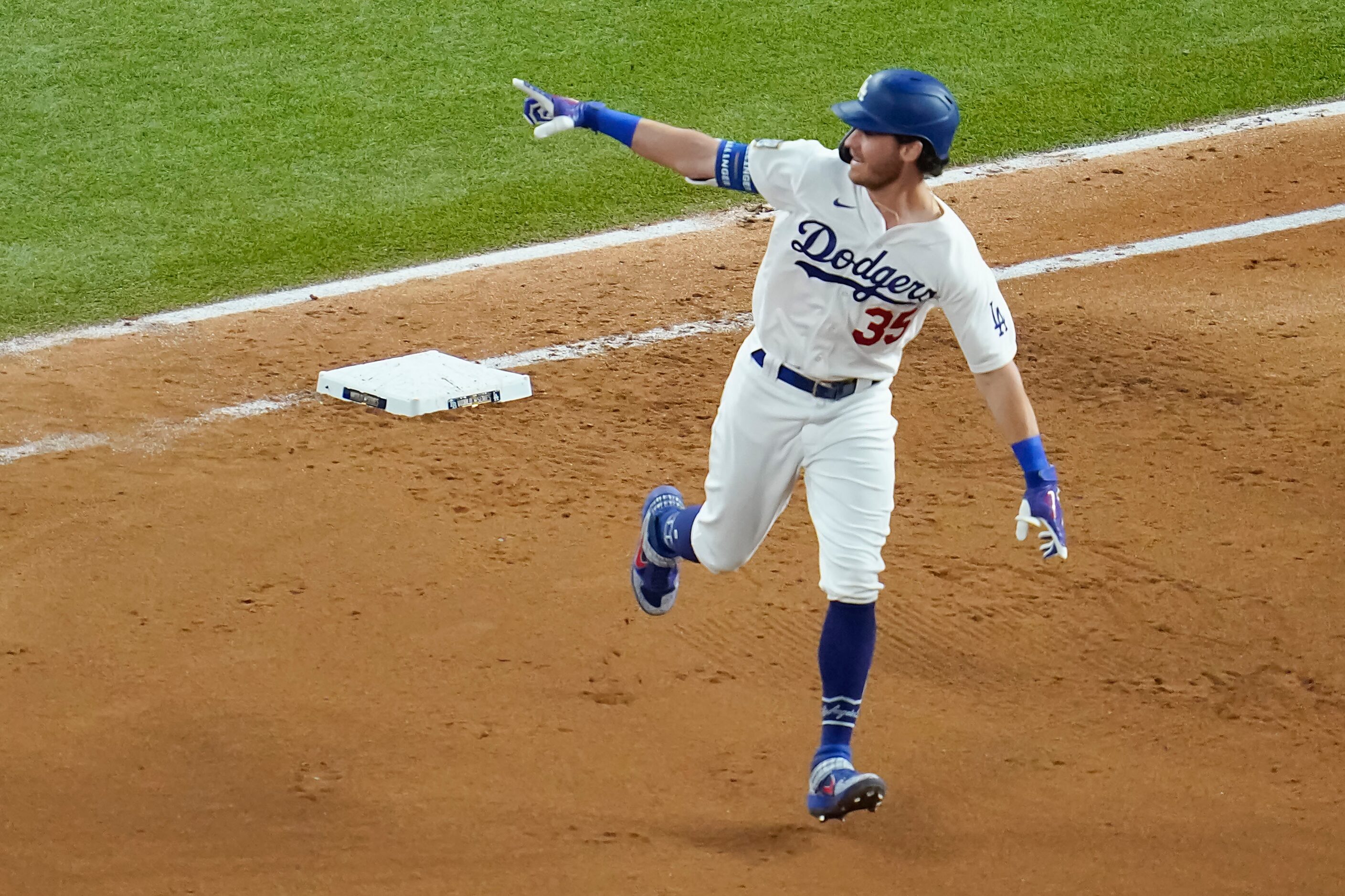 Los Angeles Dodgers center fielder Cody Bellinger celebrates as he rounds first after...