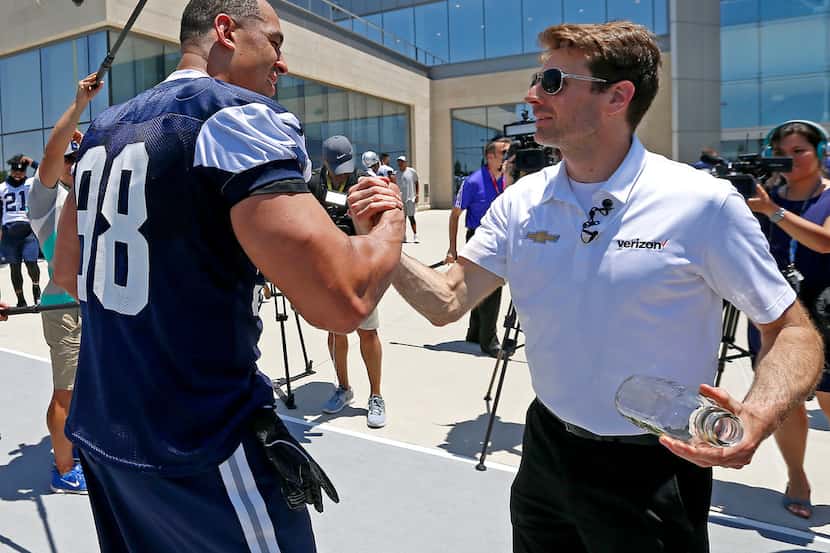 Indianapolis 500 winner Will Power, right, shakes hands with Dallas Cowboys defensive line...