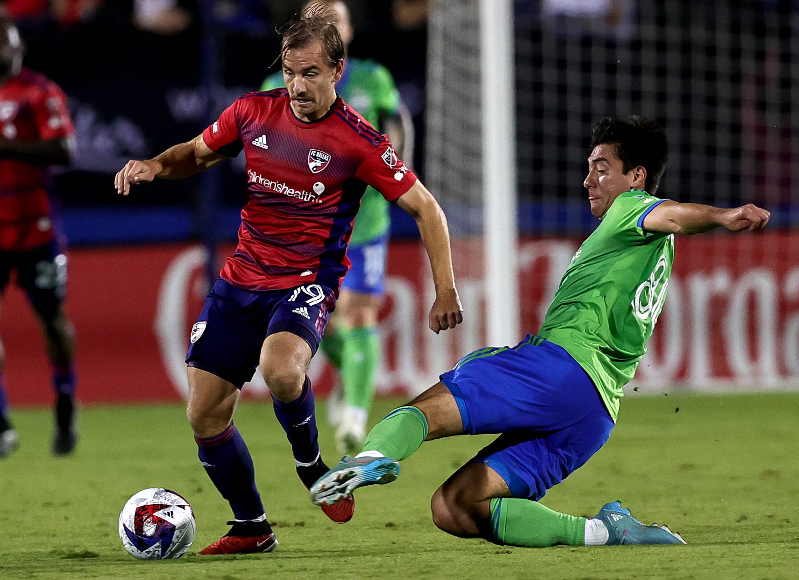 FC Dallas midfielder Paxton Pomykal (19) dribbles past Seattle midfielder Josh Atencio (84)...