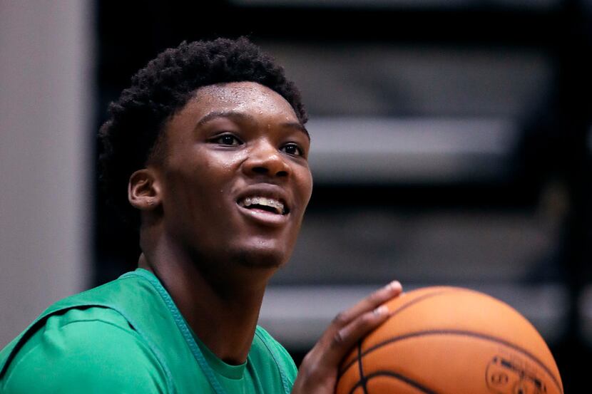 Boston Celtics NBA basketball team draft pick Robert Williams smiles while lining up a shot...