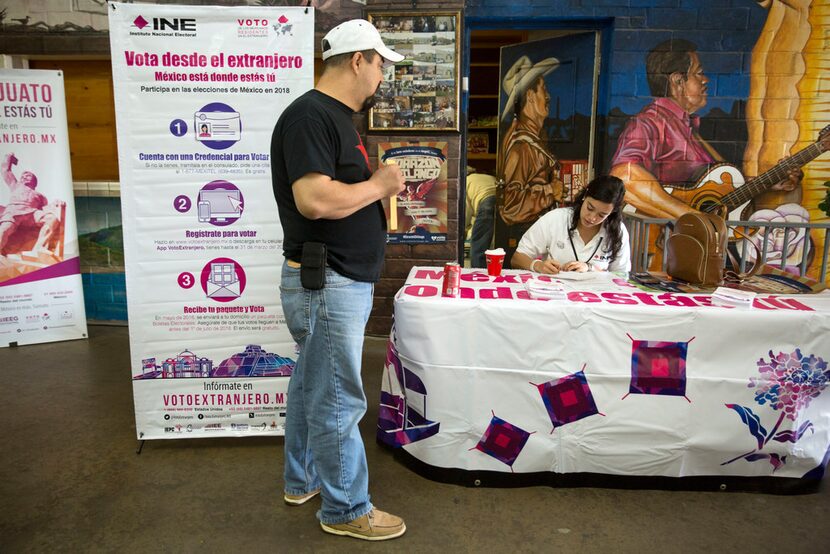 Ruben Martinez (left) registers to vote with the National Electoral Institute's Janina...