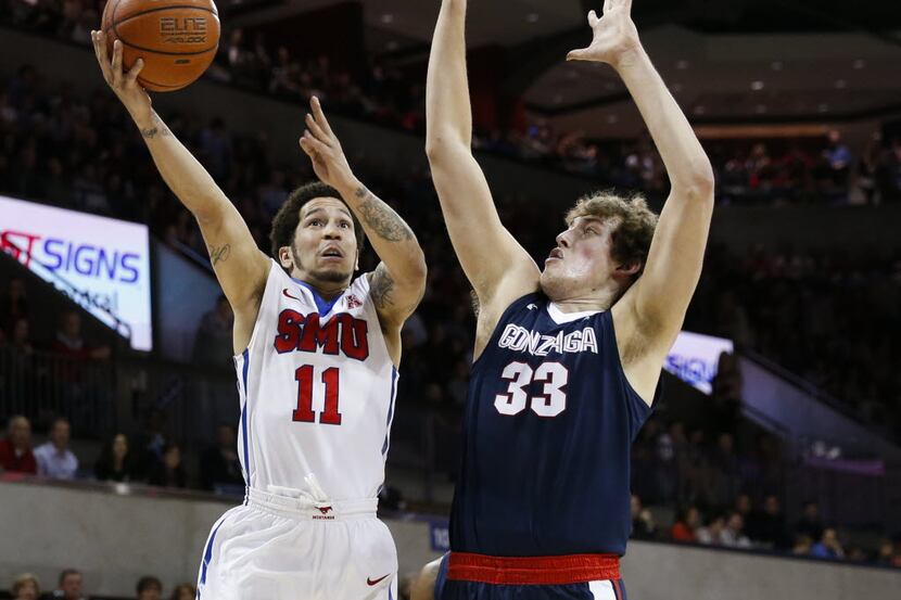 SMU guard Nic Moore (11) shoots over Gonzaga forward Kyle Wiltjer (33) during the first half...
