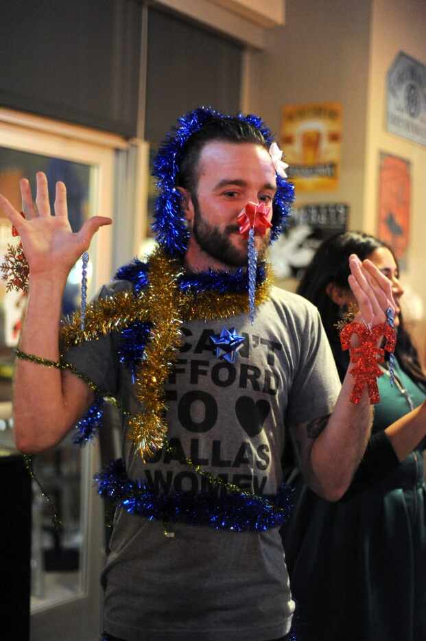 Jason Hanshew competes in the human Christmas tree decorating contest at the winter mini...