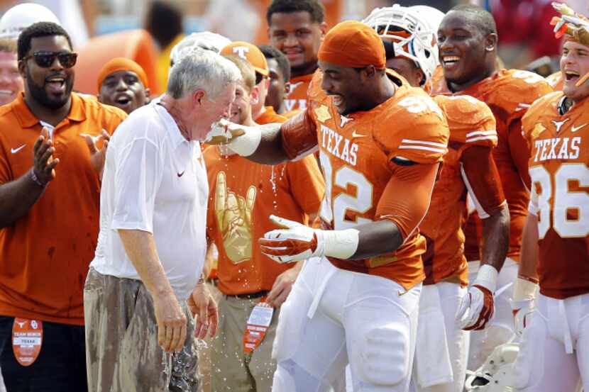 Texas Longhorns head coach Mack Brown was doused with the water cooler by defensive end...