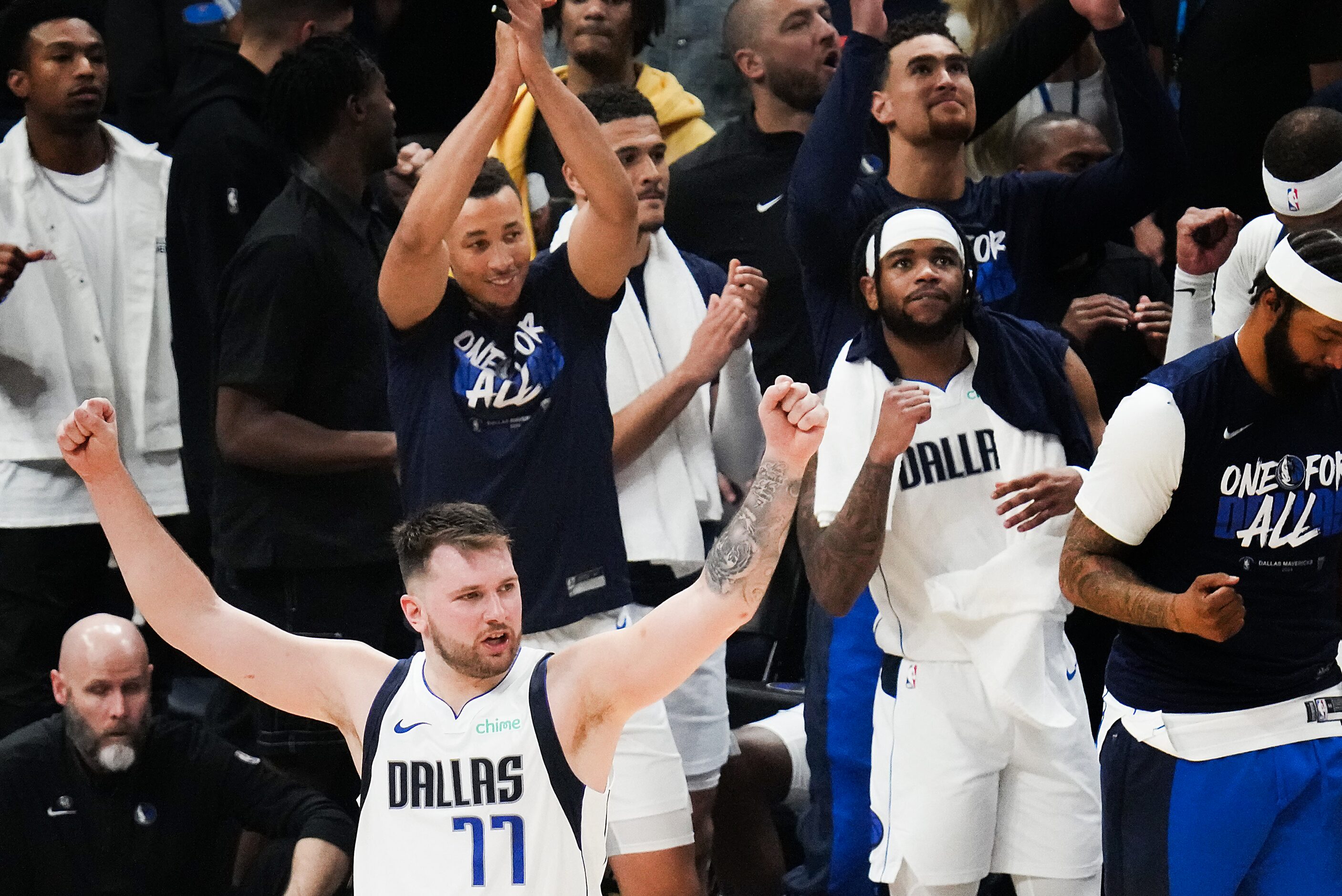 Dallas Mavericks guard Luka Doncic (77) celebrates along with the Mavericks bench after a...