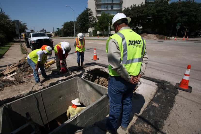 
Atmos Energy workers  replace old cast-iron gas lines with new polyethylene pipe on Wycliff...