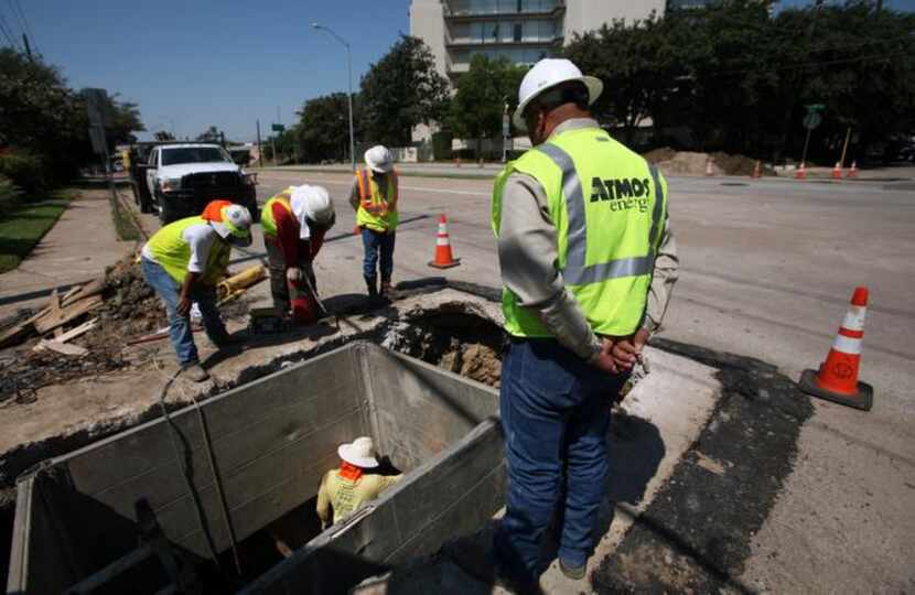 
Atmos Energy workers replace old cast iron gas lines with new polyethylene pipe on Wycliff...