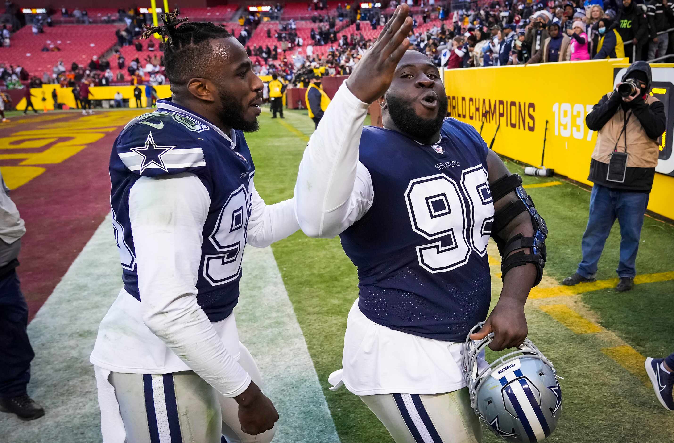 Dallas Cowboys defensive tackle Neville Gallimore blows kisses to the crowd as he leaves the...