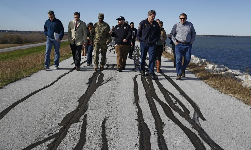 Army Corps of Engineers staff and other officials walked to a 160-foot-long slide for a news...