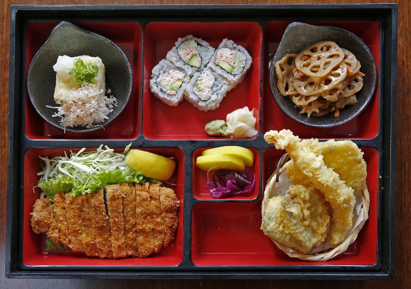 A Bento box with Kurobuto tonkatsu, tempura, sushi, Japanese pickles and more at Yama...