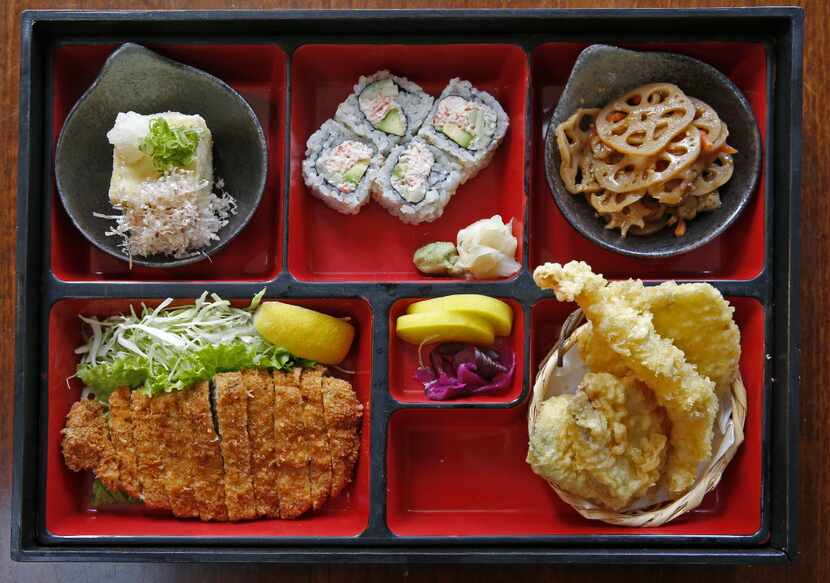 A Bento box with Kurobuto tonkatsu, tempura, sushi, Japanese pickles and more at Yama...
