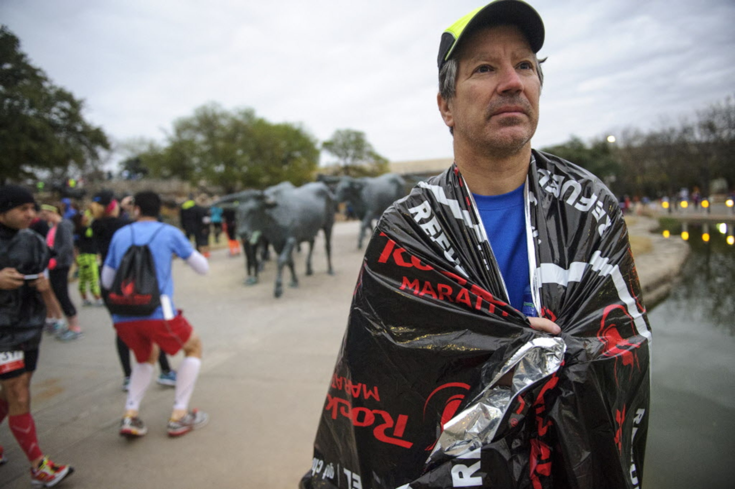 Robert Keichline warms himself using a thermal blanket prior to the start of the Dallas Rock...