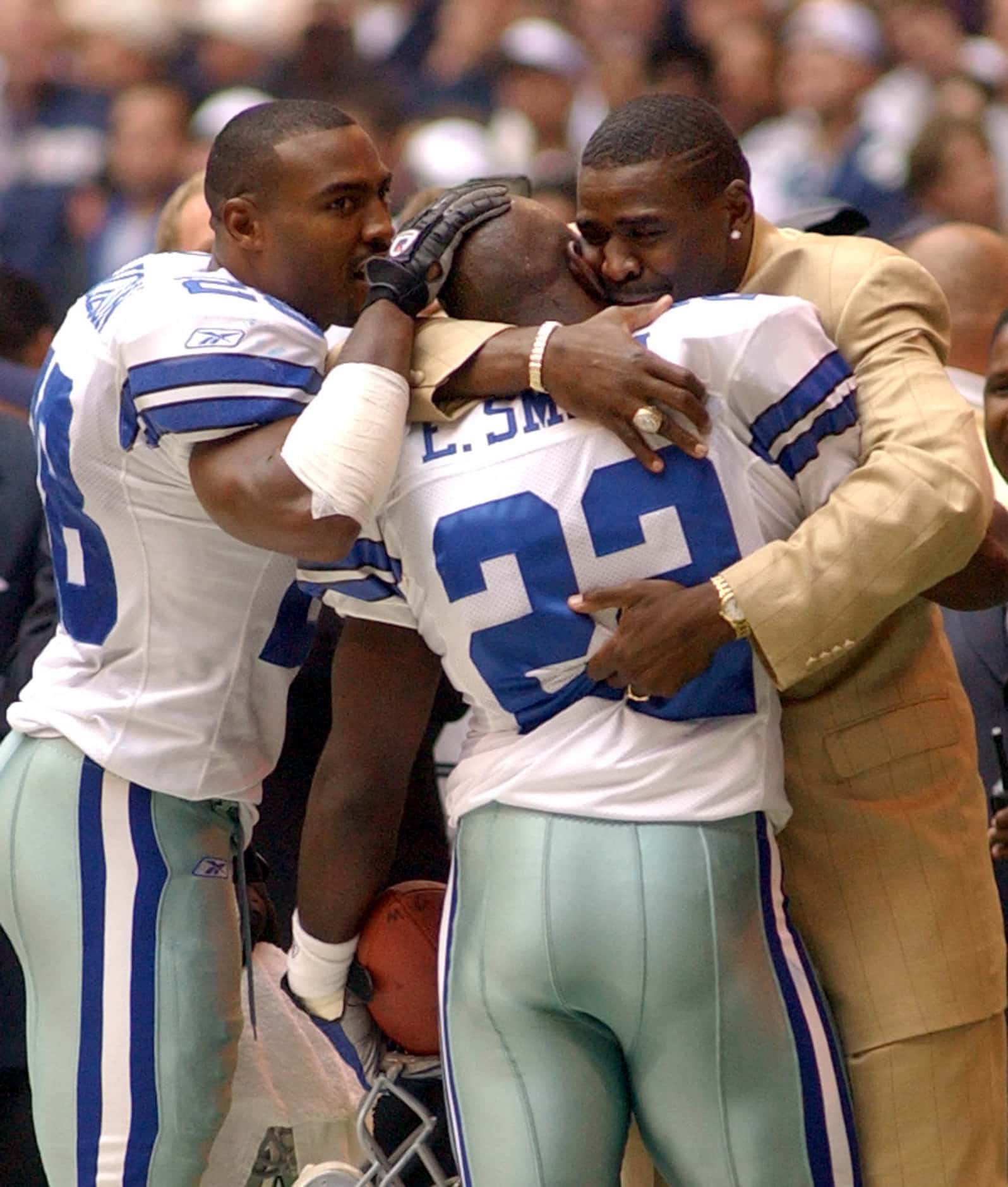 Dallas Cowboys running back Emmitt Smith (22) is congratulated by former teammate Michael...