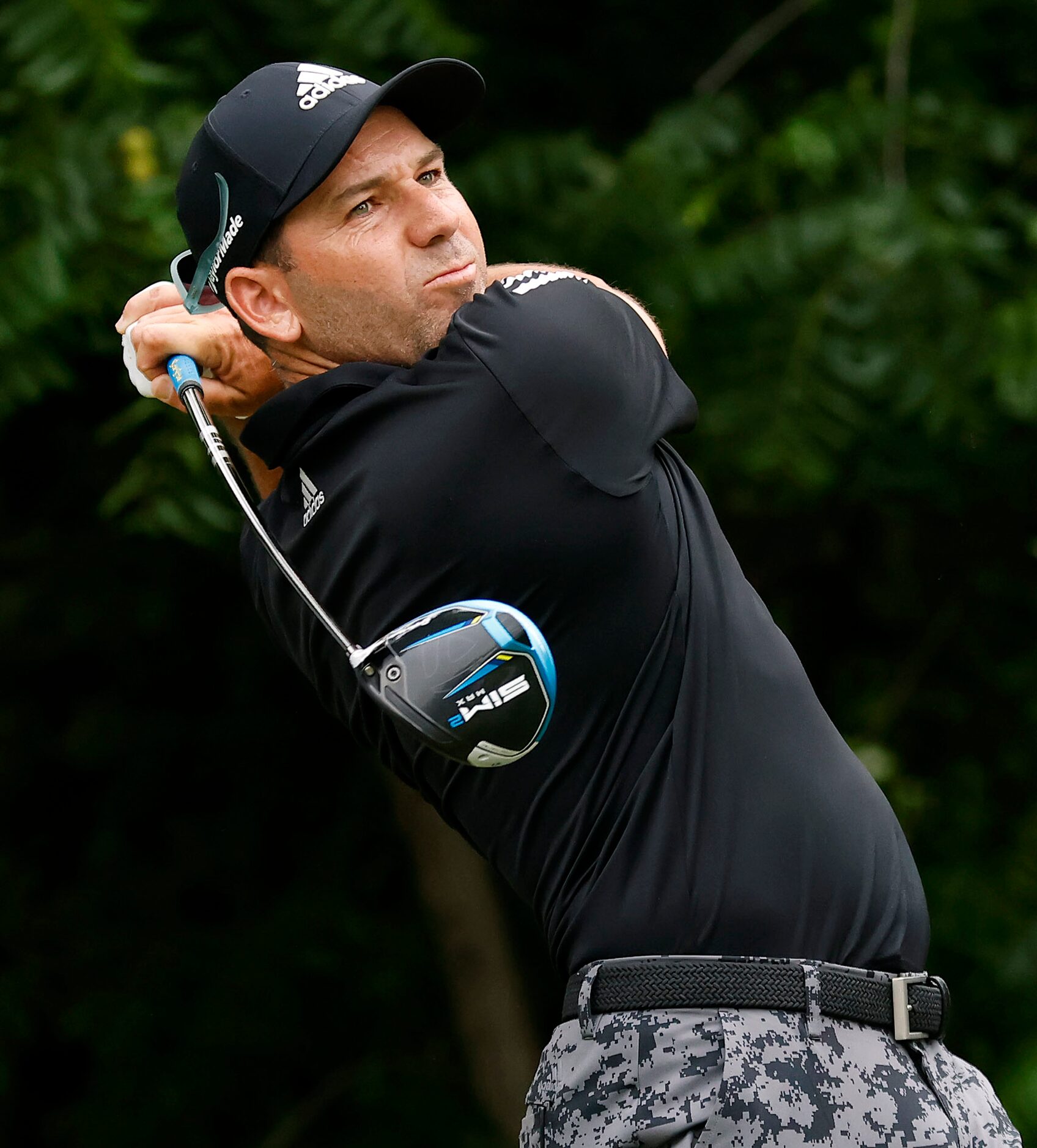 Professional golfer Sergio Garcia follows through on his drive off the No. 6 tee box during...