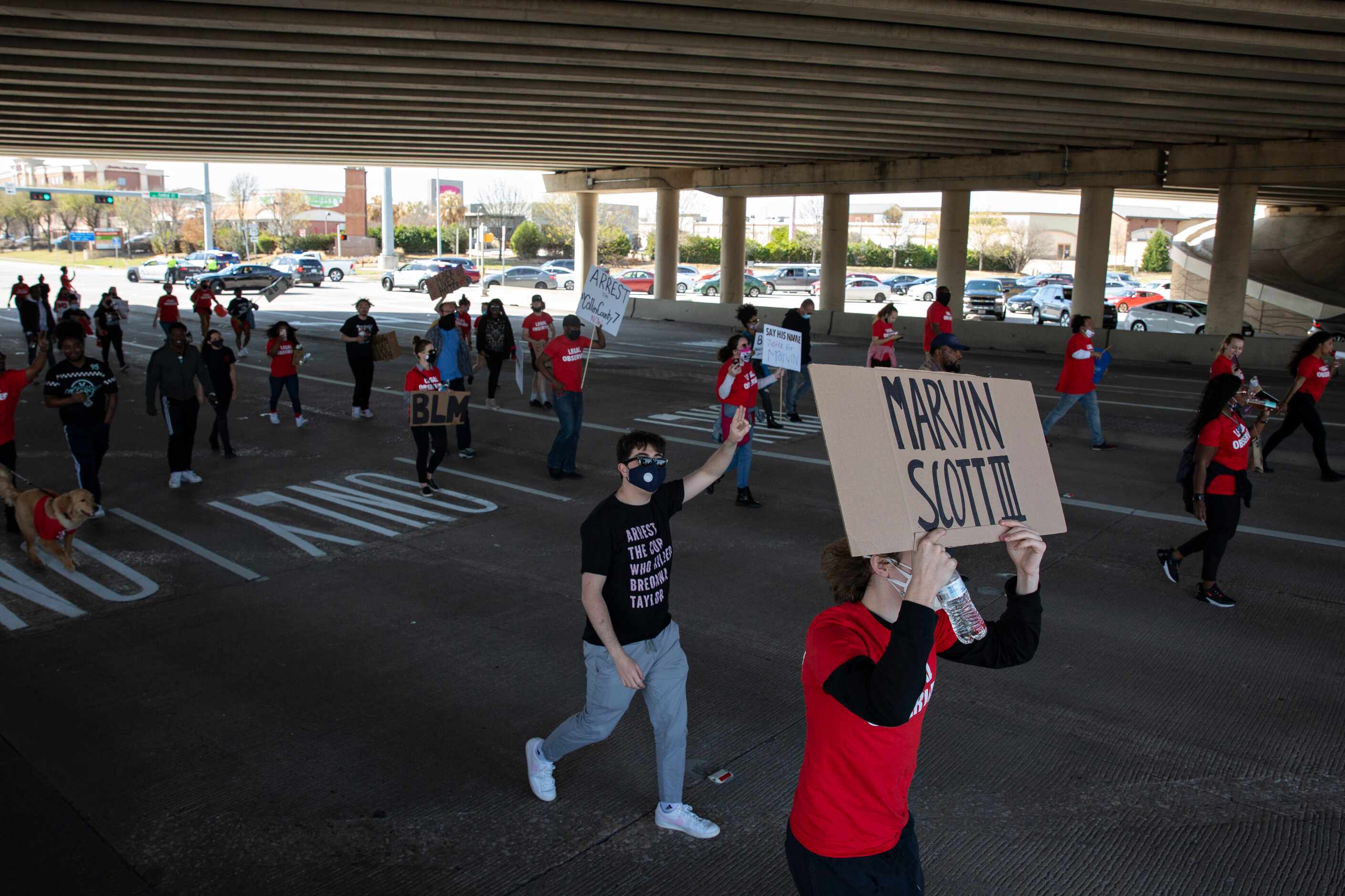 People march outside of the Allen Outlets on Sunday, March 21, 2021 demanding justice for...
