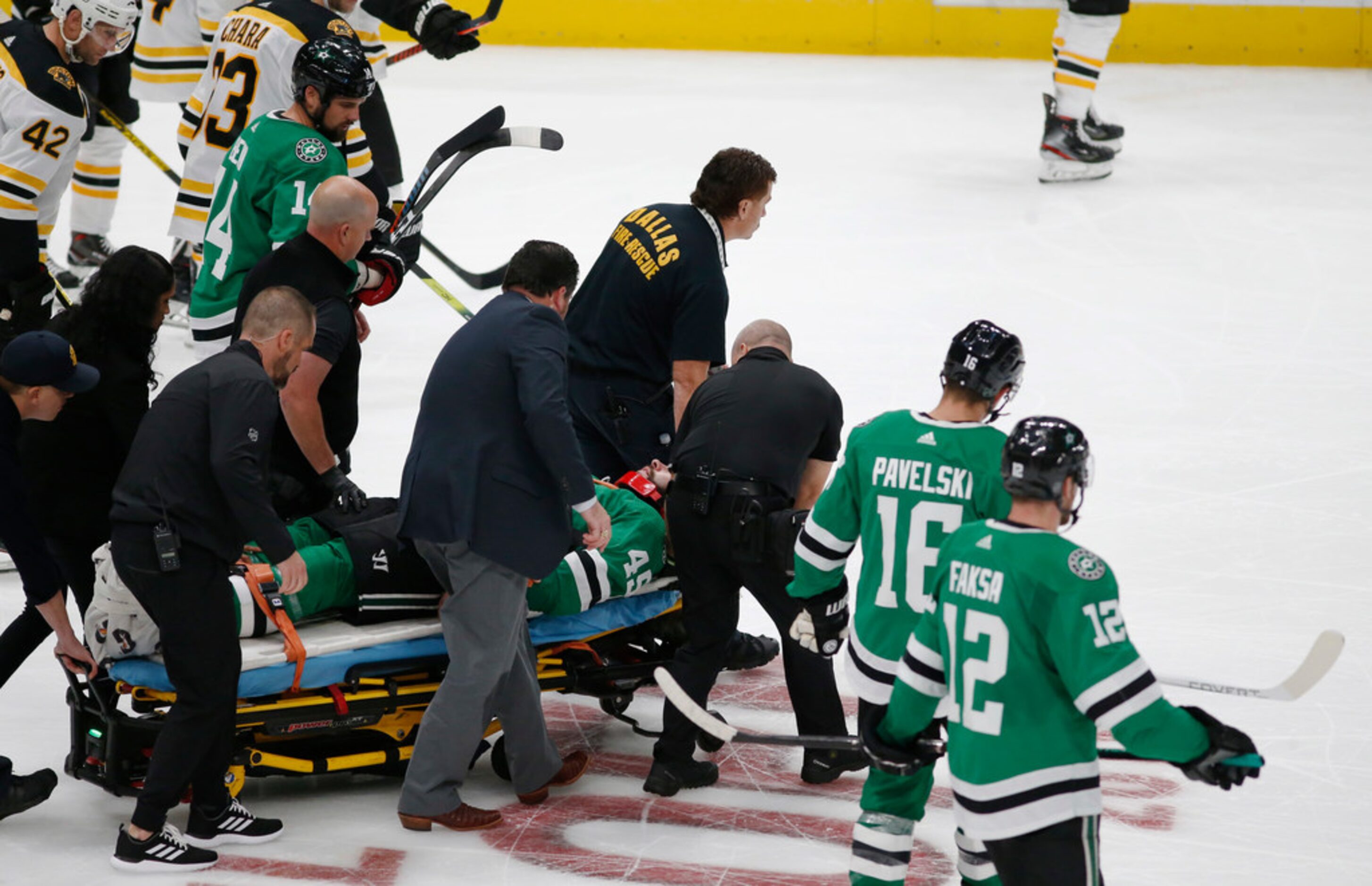 The medical team tends rolls injured player Dallas Stars defenseman Roman Polak (45) off the...