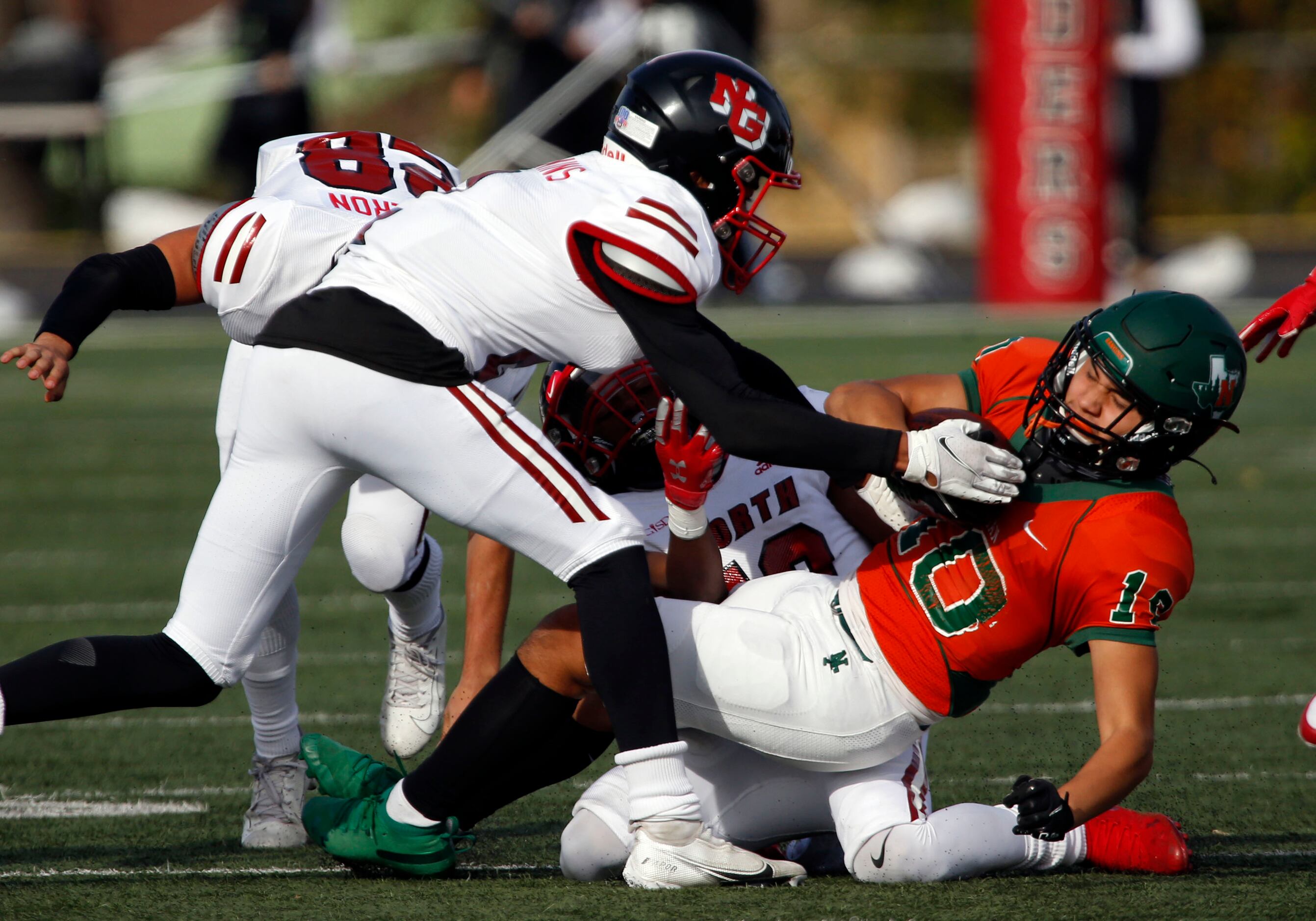 Naaman Forest’s Mike DeLuna (10) picks up a couple of yards before being stopped by the...