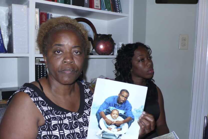 Aletha Smith of Dallas holds a photo of her son, Jabin Bogan, and his son, Jakobe in El Paso...