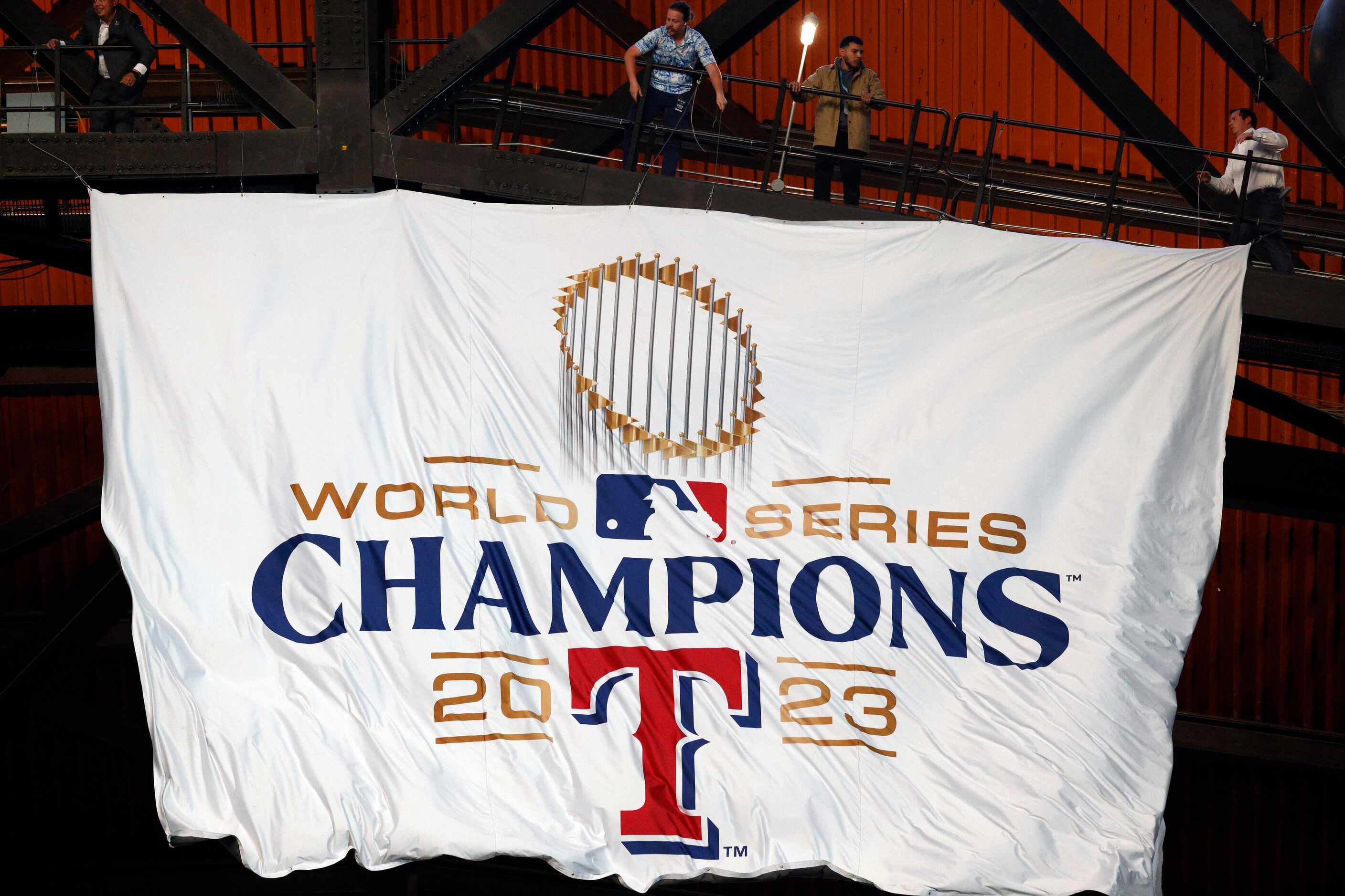 The Texas Rangers World Series championship banner is unfurled from the rafters before the...