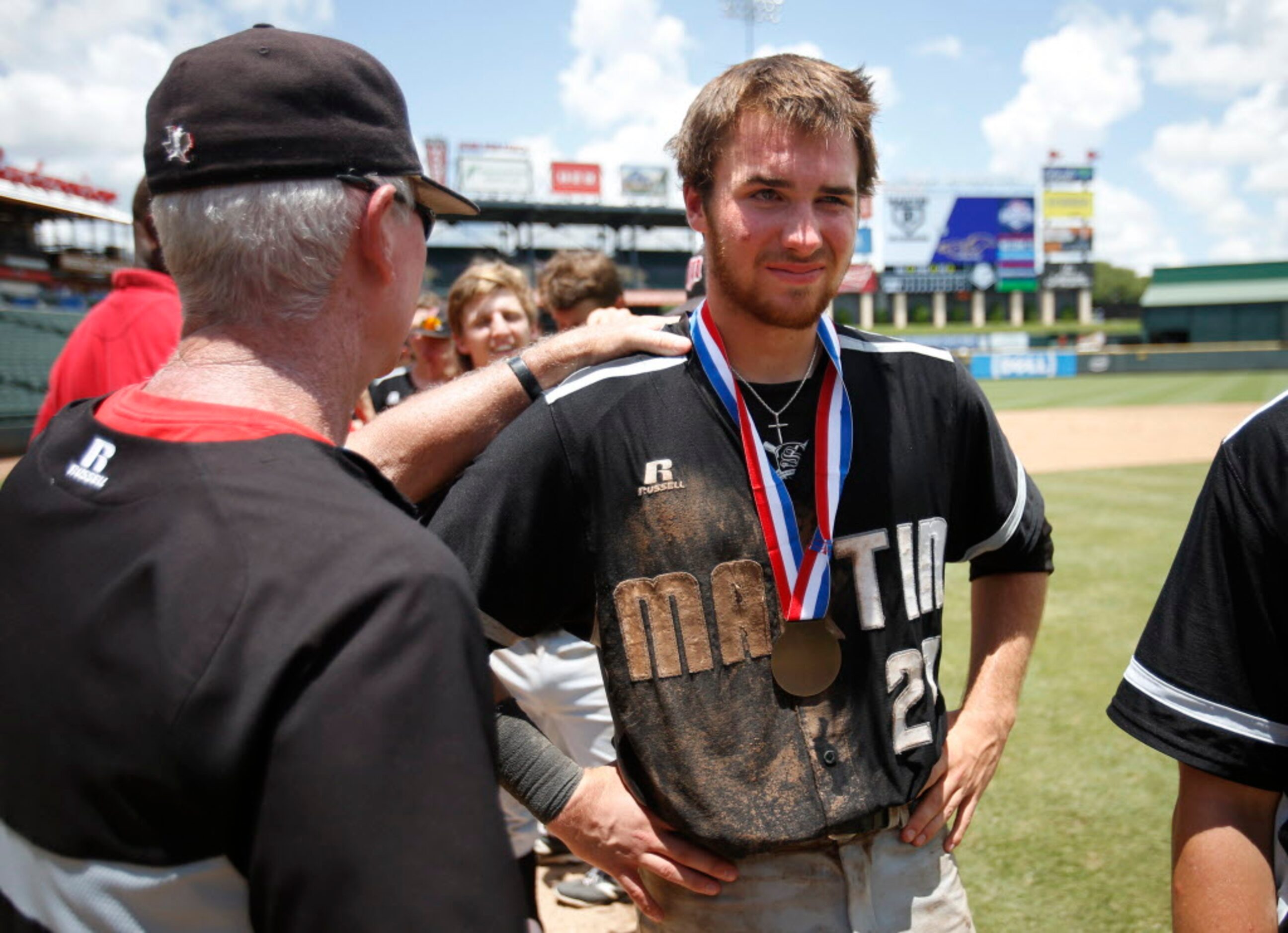 Martin's head coach Curt Culbertson talks with a dejected Aaron Fanning (27) after they lost...