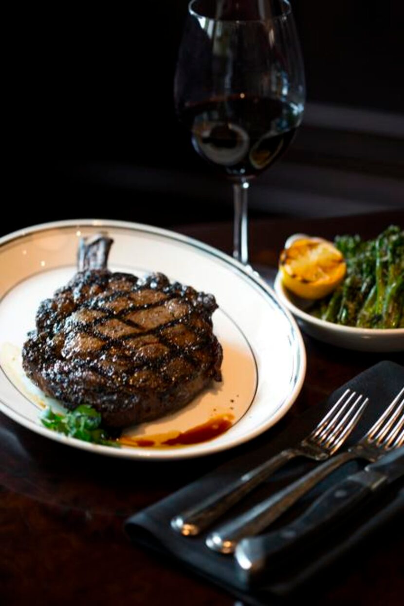 
A cowboy rib-eye steak with a side of broccolini 
