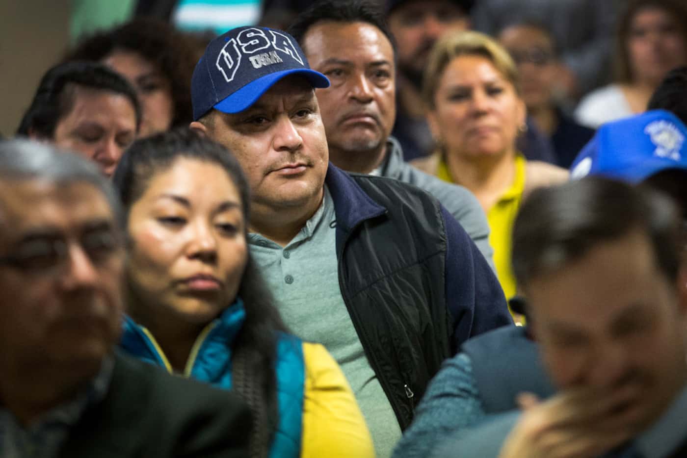 Miguel Hernandez wears a USA hat while listening to Francisco de la Torre, the Mexican...