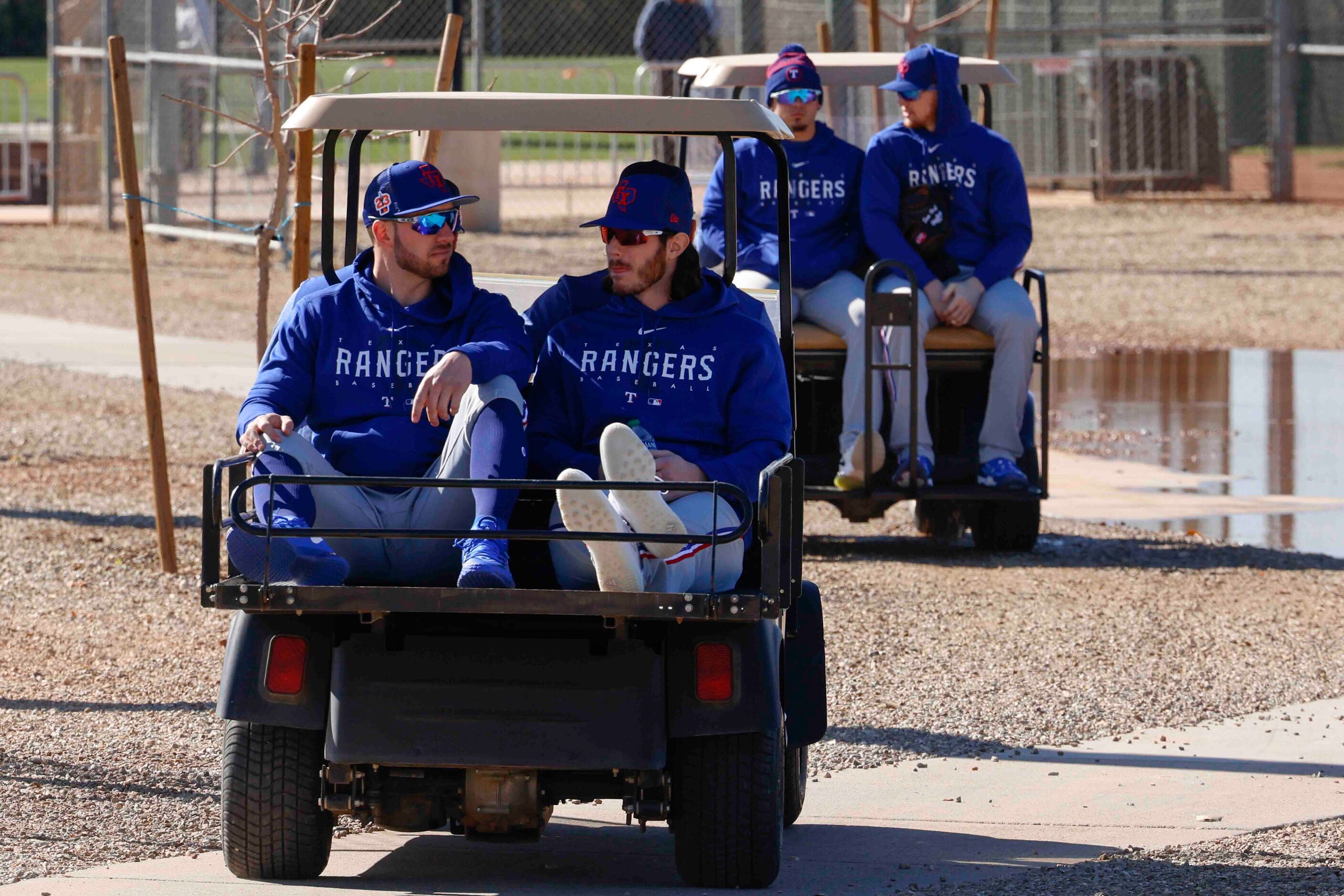 Texas Rangers players make their way into the team’s training facility during the first...