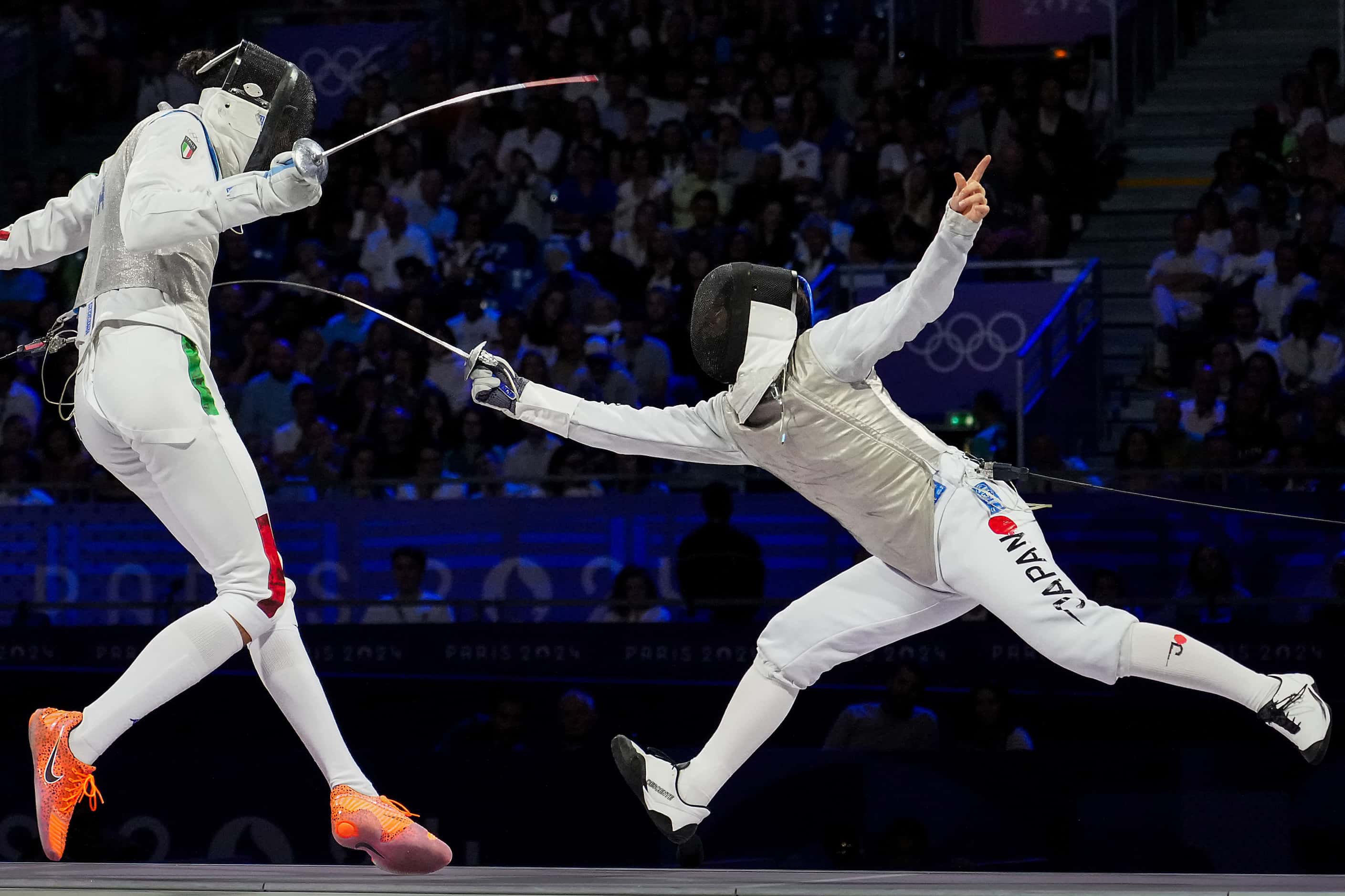 Kazuki Iimura of Japan scores a point against Tommaso Marini of Italy during the men’s foil...