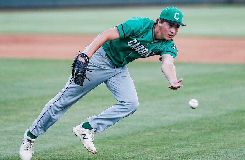 Southlake Carroll starting pitcher Cutter Sippel tosses the ball to first to force out...