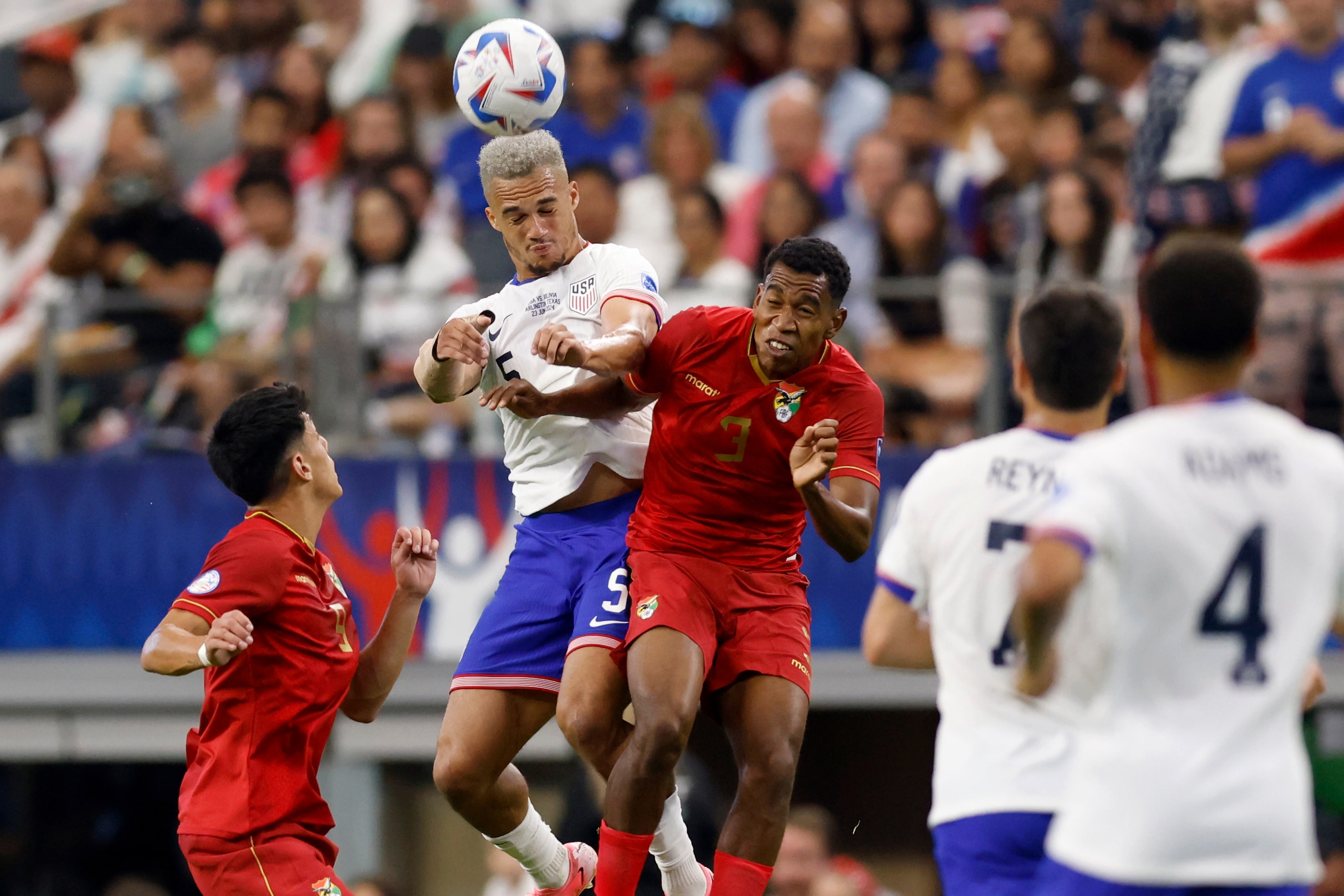 United States defender Antonee Robinson (5) and Bolivia defender Diego Medina (3) jump to...