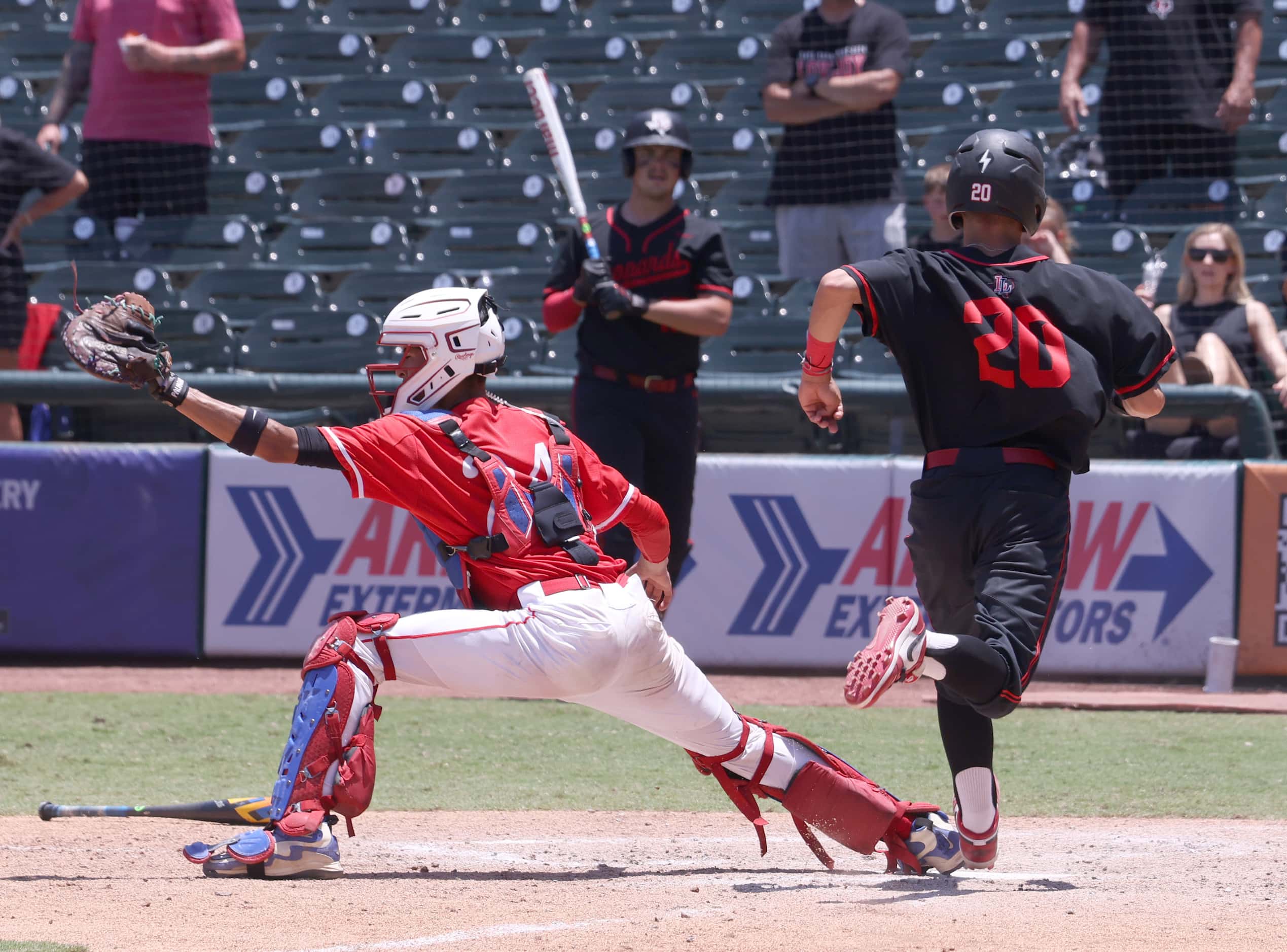 Lovejoy baserunner Joey Brooks (20) scores on a bases loaded force at the plate as Grapevine...