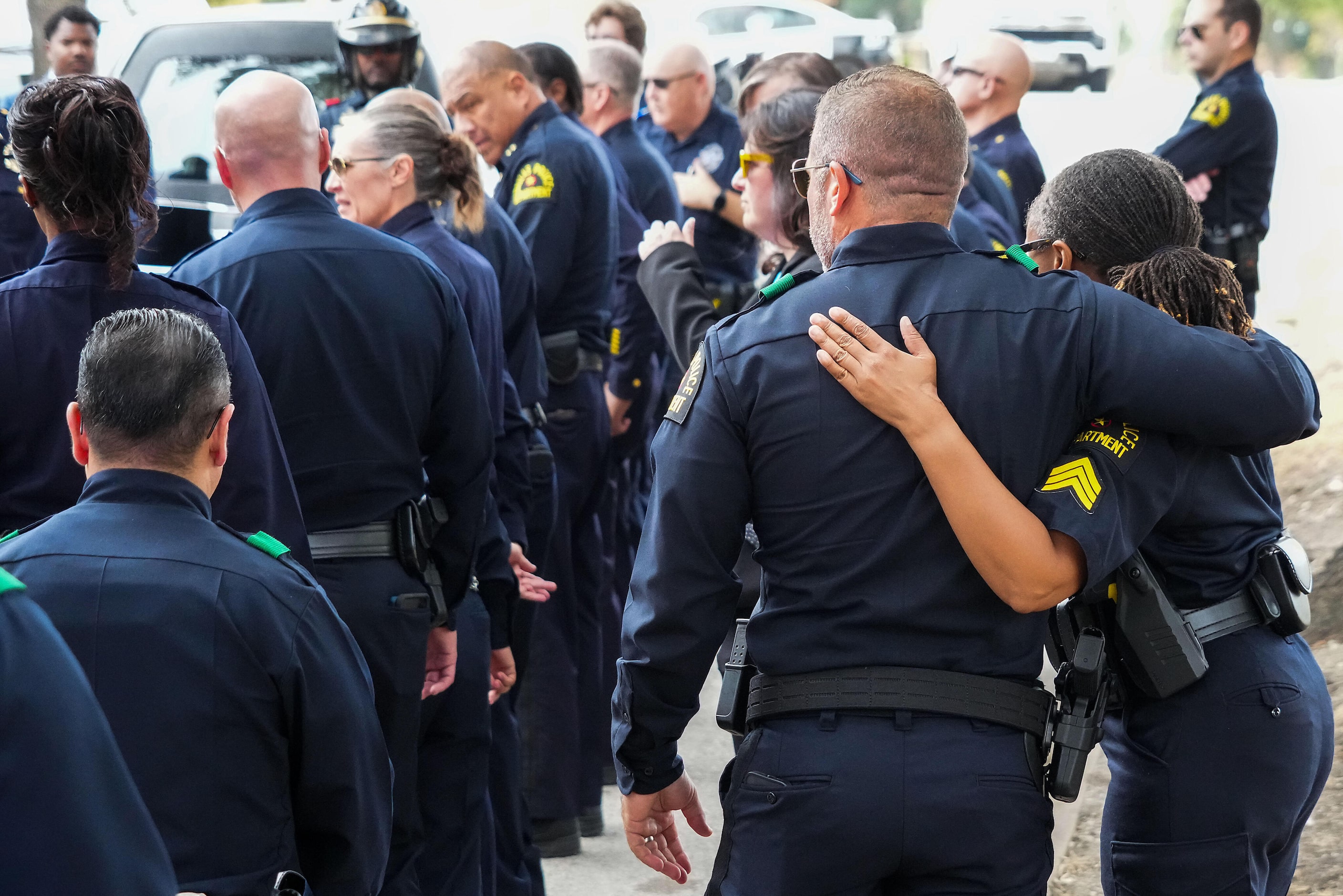 Dallas police look on as the hearse arrives at Restland Funeral Home as fallen Dallas Police...