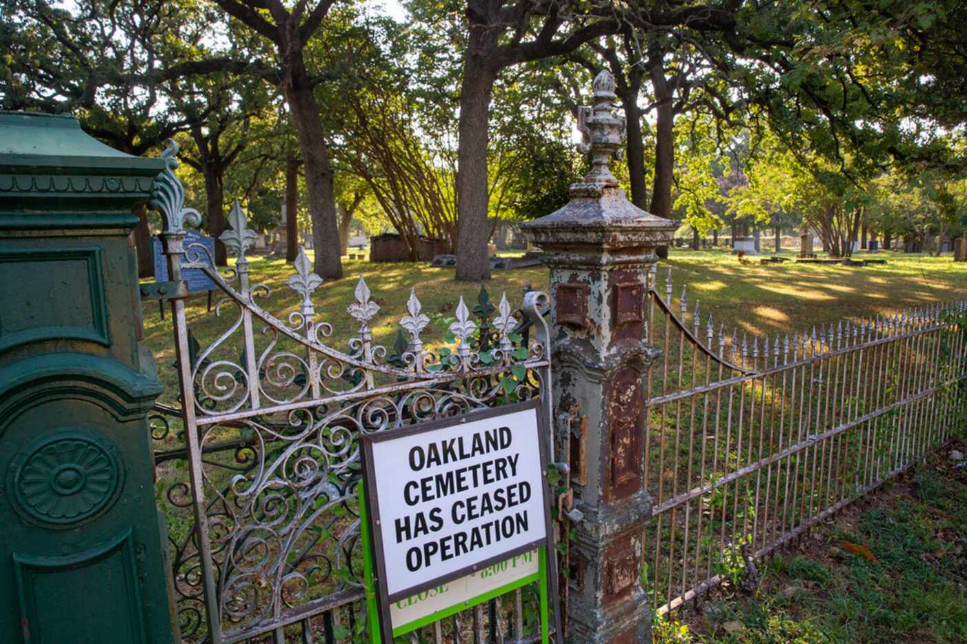 A sign warns visitors that the Oakland Cemetery is no longer operating. It has caught...