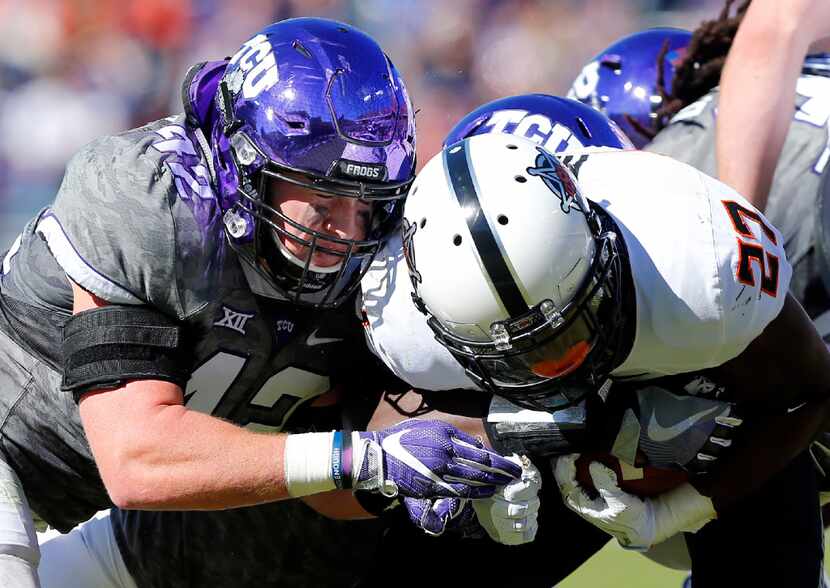 TCU Horned Frogs linebacker Ty Summers (42) puts the hit Oklahoma State Cowboys running back...