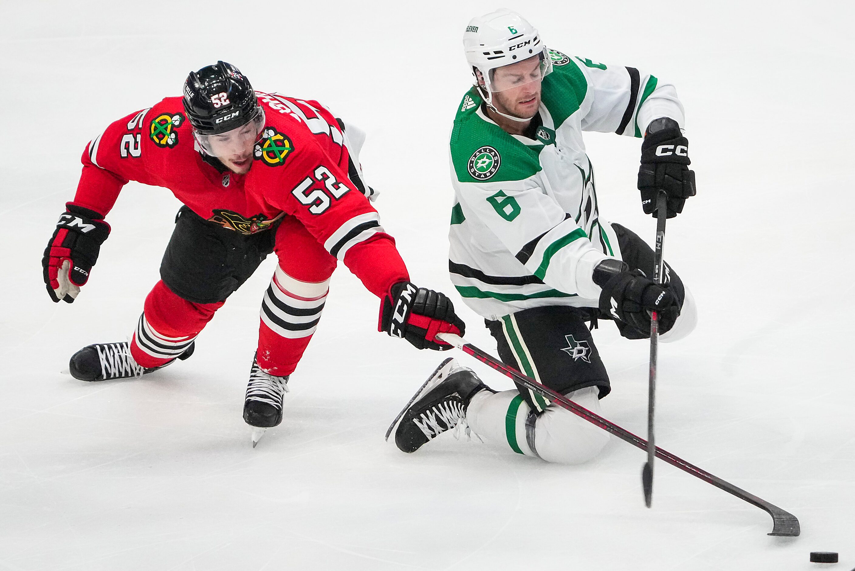 Dallas Stars defenseman Colin Miller (6) controls the puck against Chicago Blackhawks center...