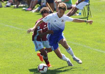 Riley O'Donnell of Solar SC (in white/blue) against Colorado Rapids Academy side.