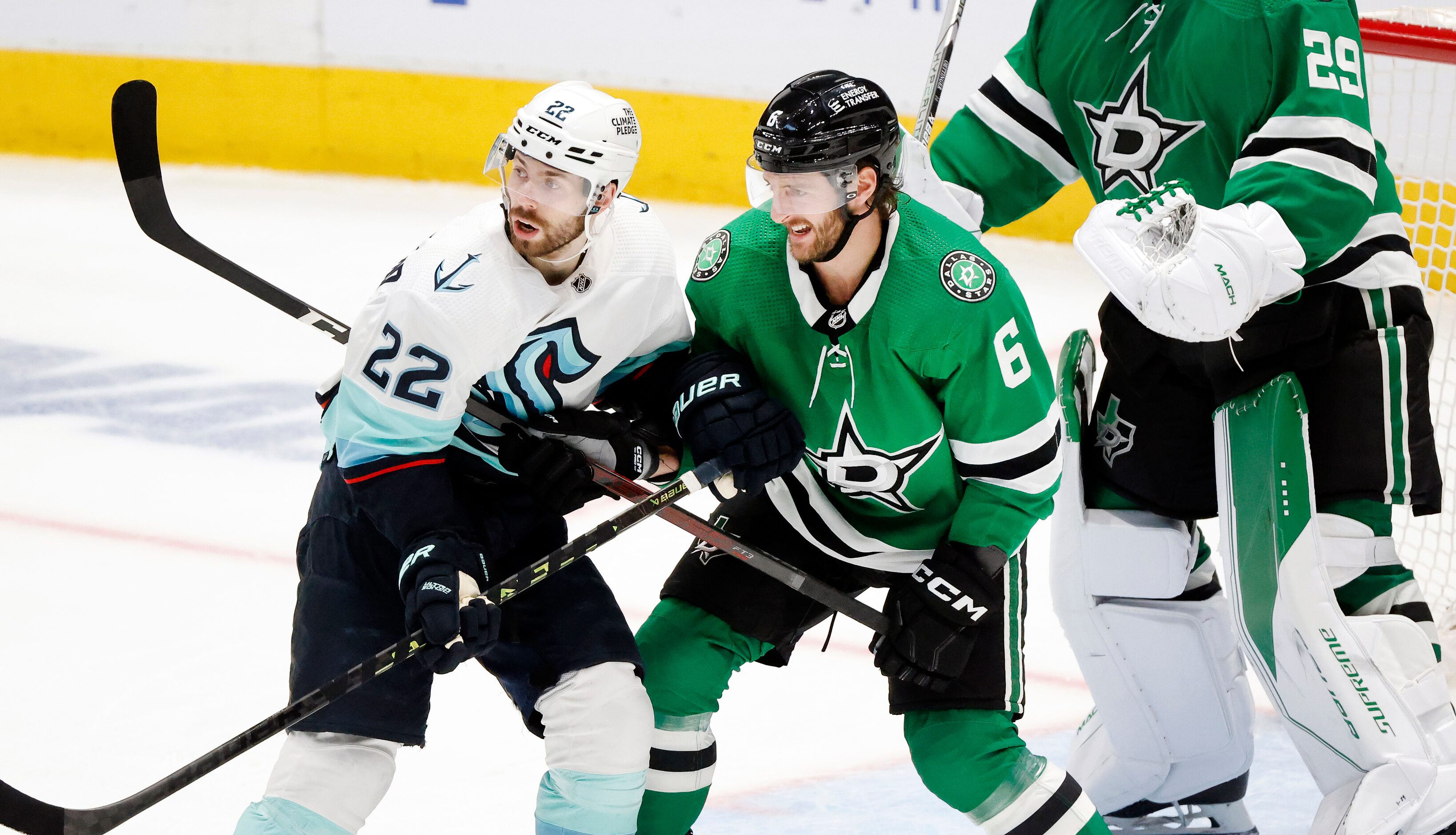 Dallas Stars defenseman Colin Miller (6) and Seattle Kraken right wing Oliver Bjorkstrand...